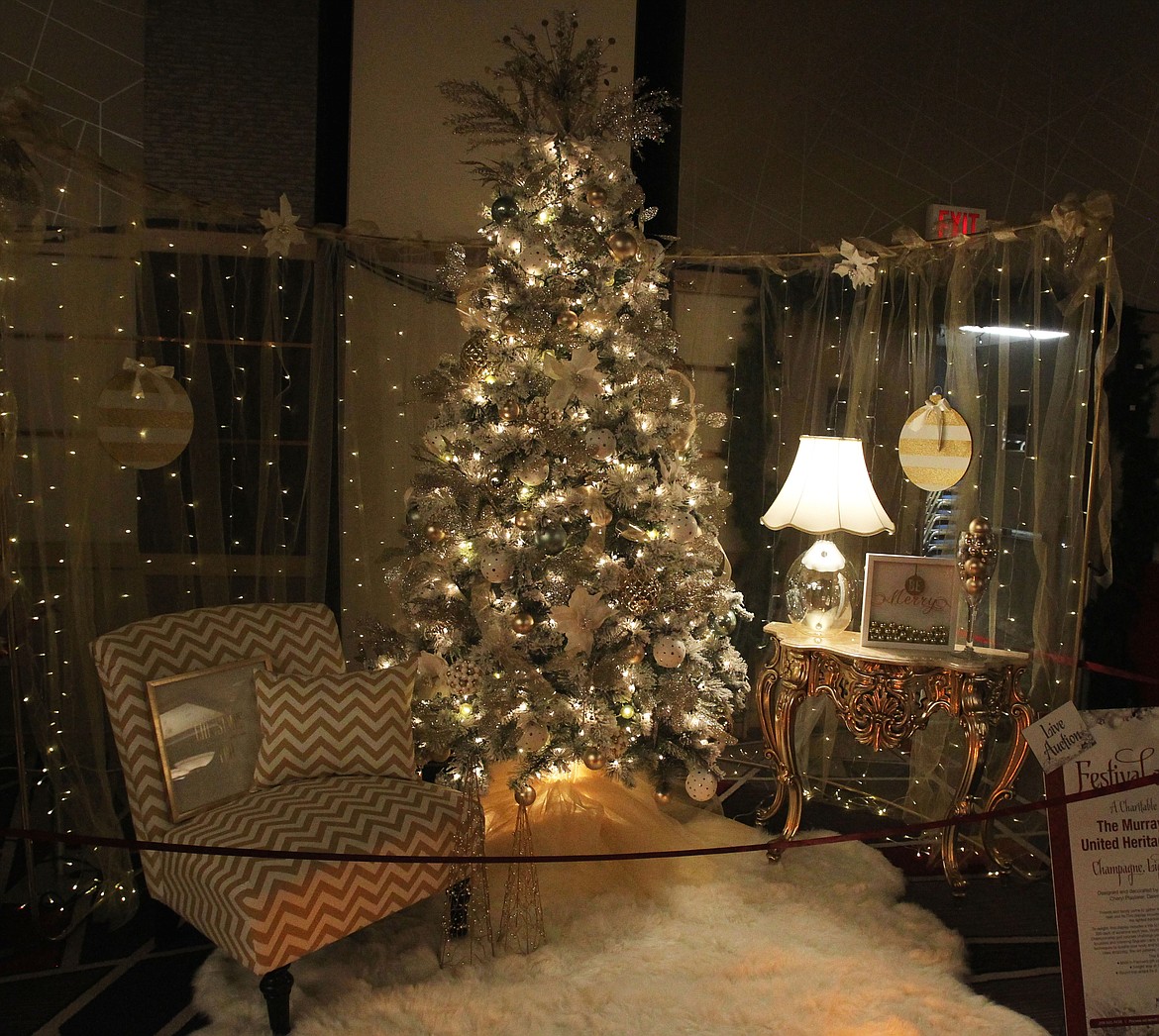 &quot;Champagne, Lights and Delights&quot; by The Murray Group and United Heritage Insurance: Friends and family come together to enjoy the holidays and toast to loved ones near and far. This display includes ornate furniture and a lighted backdrop built by Brian Kempton. (DEVIN WEEKS/Press)