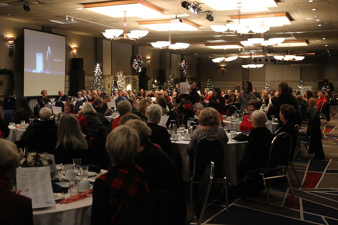 Several tables of guests stood during different verses of &quot;The 12 Days of Christmas&quot; sing-a-long during the Festival of Trees Brunch in The Resort on Saturday. The Festival continues with Family Day and the Children's Workshop today. Fashion show events will take place on Monday. (DEVIN WEEKS/Press)