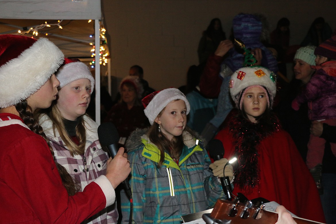 (Photo by CAROLINE LOBSINGER)
Members of the Belle Tones sing a Christmas carol at Friday's Christmas tree lighting ceremony at Jeff Jones Town Square.