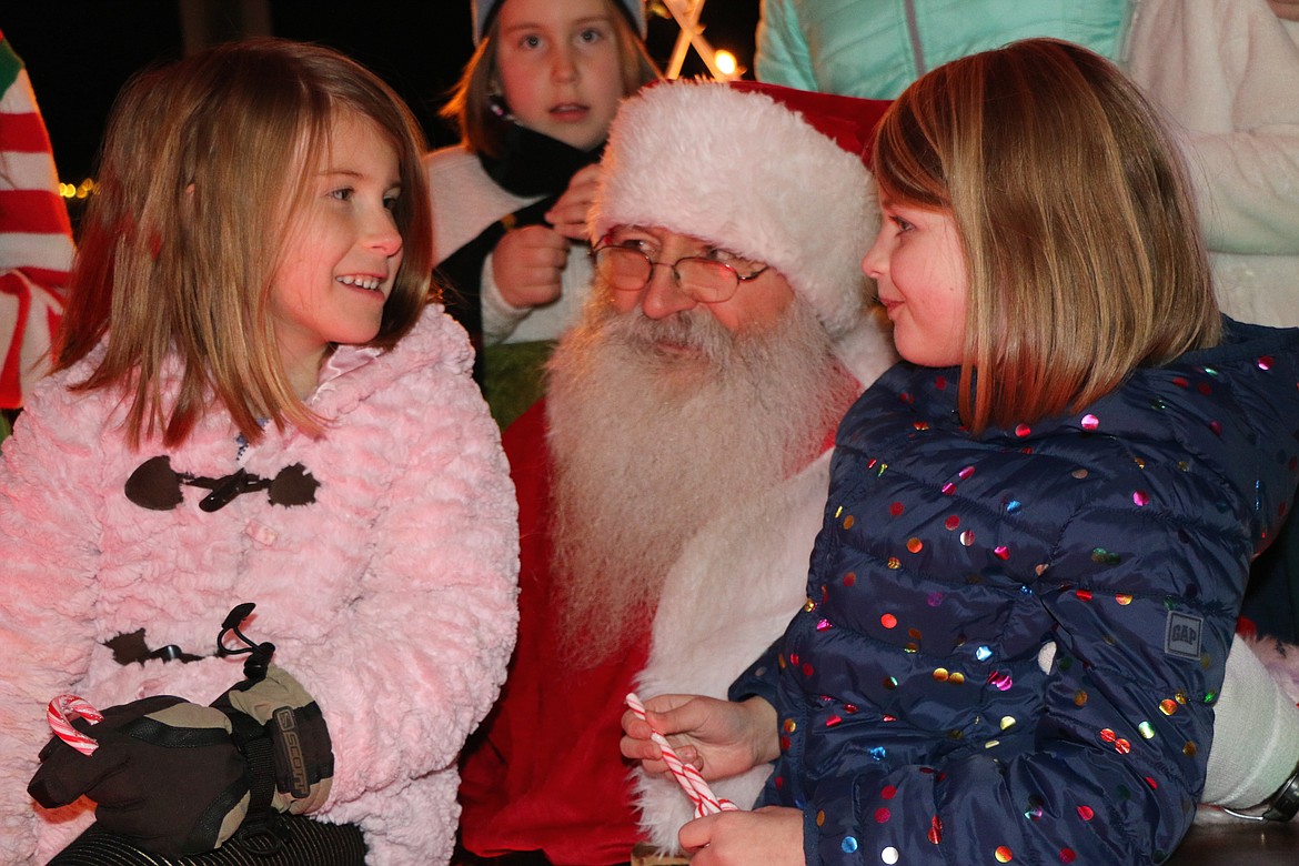 (Photo by CAROLINE LOBSINGER)
A pair of area youth say hello to Santa as he stopped by the town Christmas tree lighting ceremony to say hello, hear Christmas wishes and help the community kick off the holiday season.