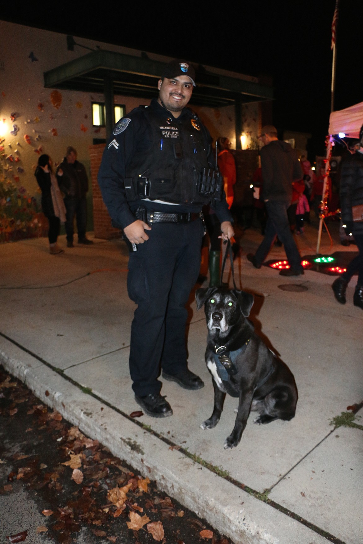 (Photo by CAROLINE LOBSINGER)
Sandpoint Police Officer Michael Valenzuela and his canine partner were on hand at Friday's Christmas tree lighting ceremony to help the community celebrate.