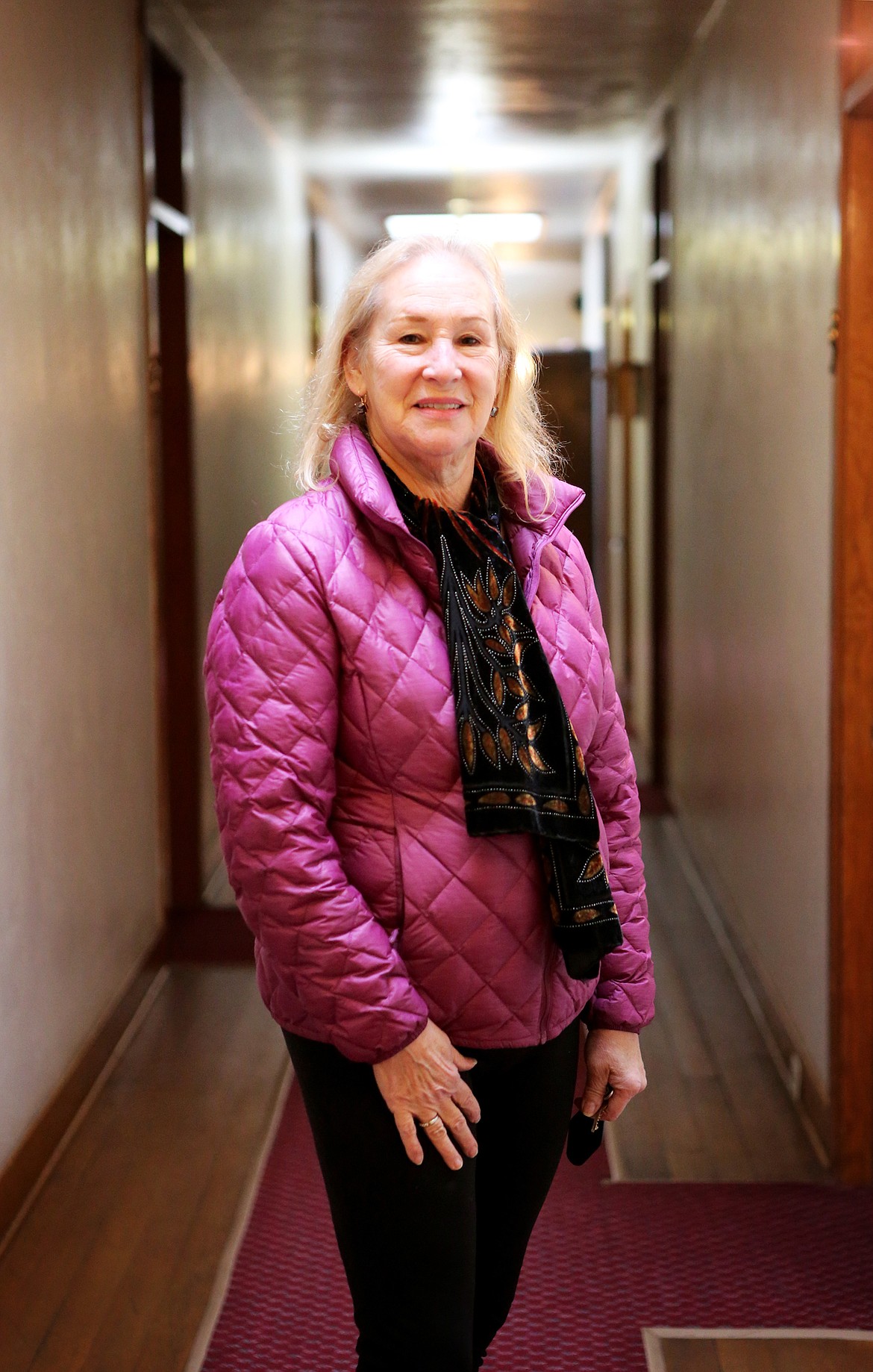 Leslee Smith, who owns the Symes Hot Springs Hotel with her husband Dan, poses for a portrait in an upstairs hallway. The Smiths purchased the hotel in 1996. (Mackenzie Reiss/Daily Inter Lake)