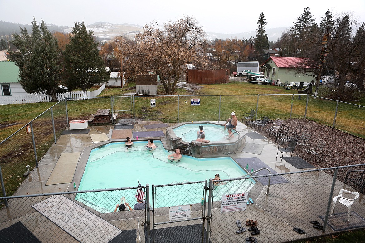 Symes Hot Springs Hotel visitors relax in mineral water pools. Water in the outer pool is roughly 101 degrees, while the octagonal pool hits temperatures of 108 degrees.