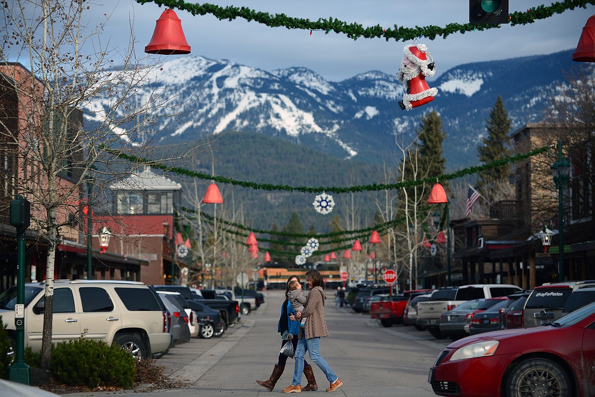 Shoppers walk along East Second Street at Central Avenue in Whitefish during a Small Business Saturday event on Nov. 25. (Casey Kreider/Daily Inter Lake)