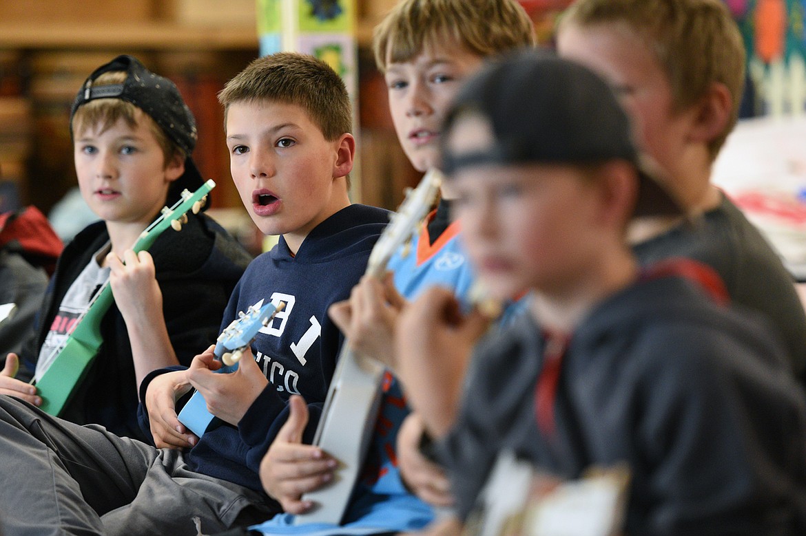 From left, fourth-graders Tommy Roland, Asher Knopik and Austin Savik play the ukulele in Heather Epperly&#146;s class at Bigfork Elementary School on Wednesday, Nov. 14. (Casey Kreider/Daily Inter Lake)