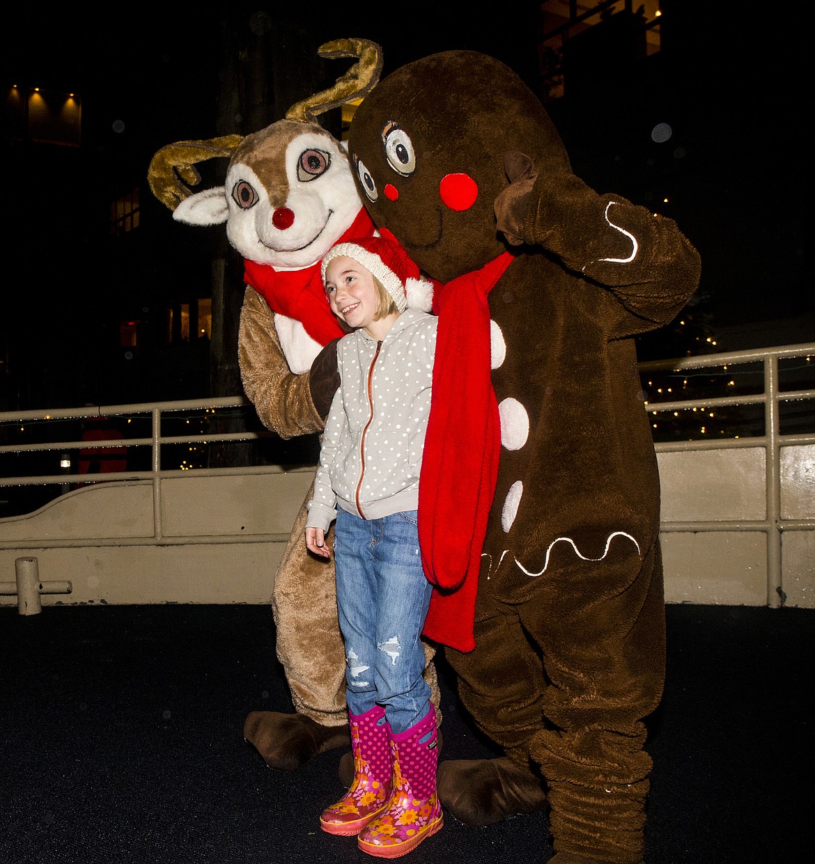 LOREN BENOIT/PressRuby Krajic, 9, takes a picture with The Gingerbread Man and Rudolph Tuesday night aboard a Holiday Light Show Media Cruise.