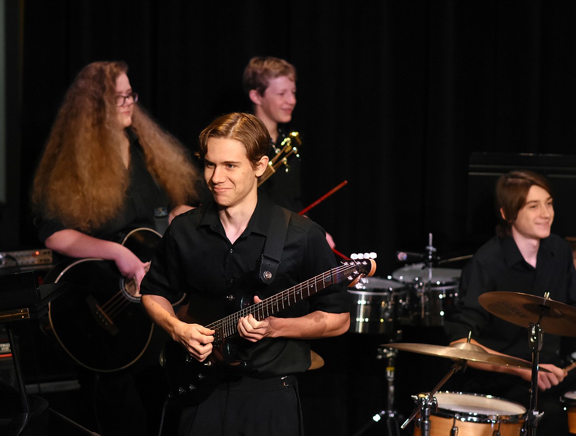 Port Nugent smiles to the audience while playing the guitar during a recent performance at Whitefish High School. The high school Percussion Ensembel and Birdland Jazz Combo performed for Muldown Elementary students. (Heidi Desch/Whitefish Pilot)