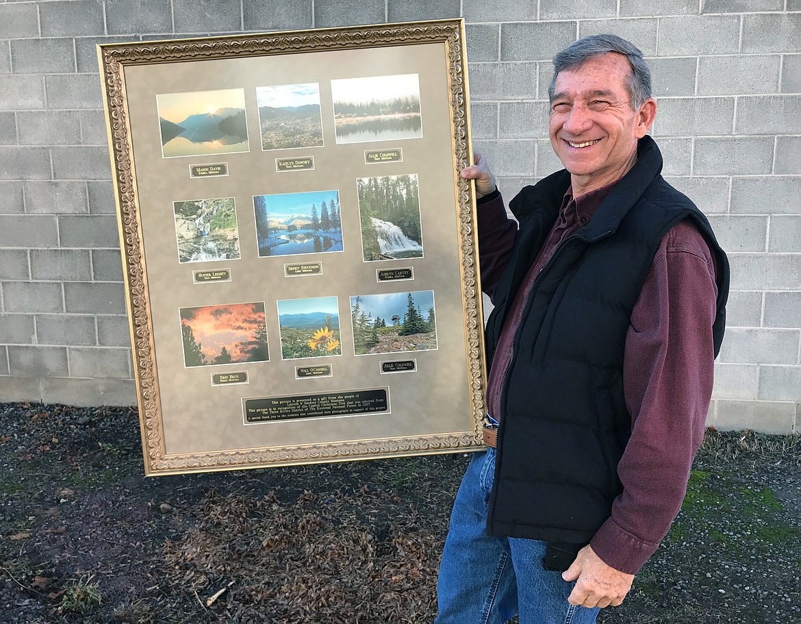 Lincoln County Commissioner Jerry Bennett on Monday holds a shadowbox that contains the contest-winning photos of Lincoln County high school students who will travel to Washington, D.C. for the lighting of the U.S. Capitol Christmas Tree. (John Blodgett/The Western News)