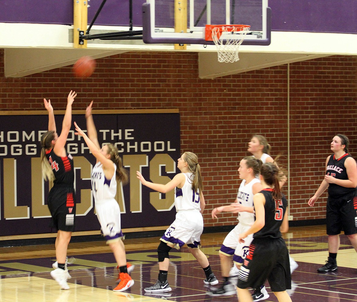 Miner Megan Morin puts a shot up over the outstretched hands of Taeya Sheppard.