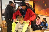 Firefighters hand out coats to kids in need
