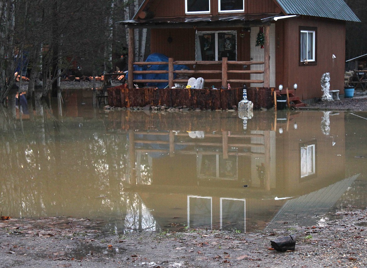 Water from a flooding Libby Creek encroach upon a Pinewood Village home Friday morning in Libby. (Courtesy photo)