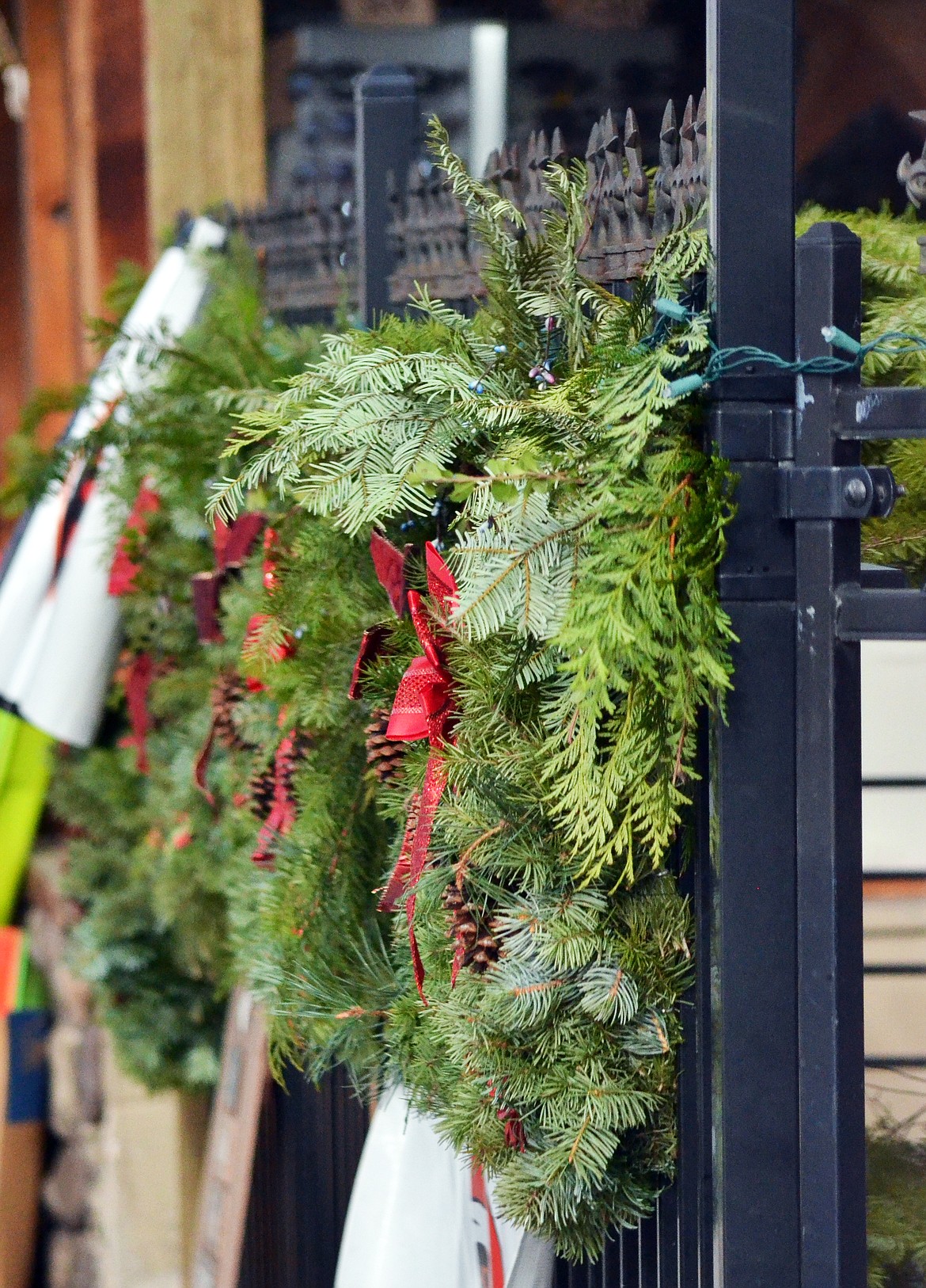 Wreathes and Christmas tree&#146;s line the black fence at the Mangy Moose.