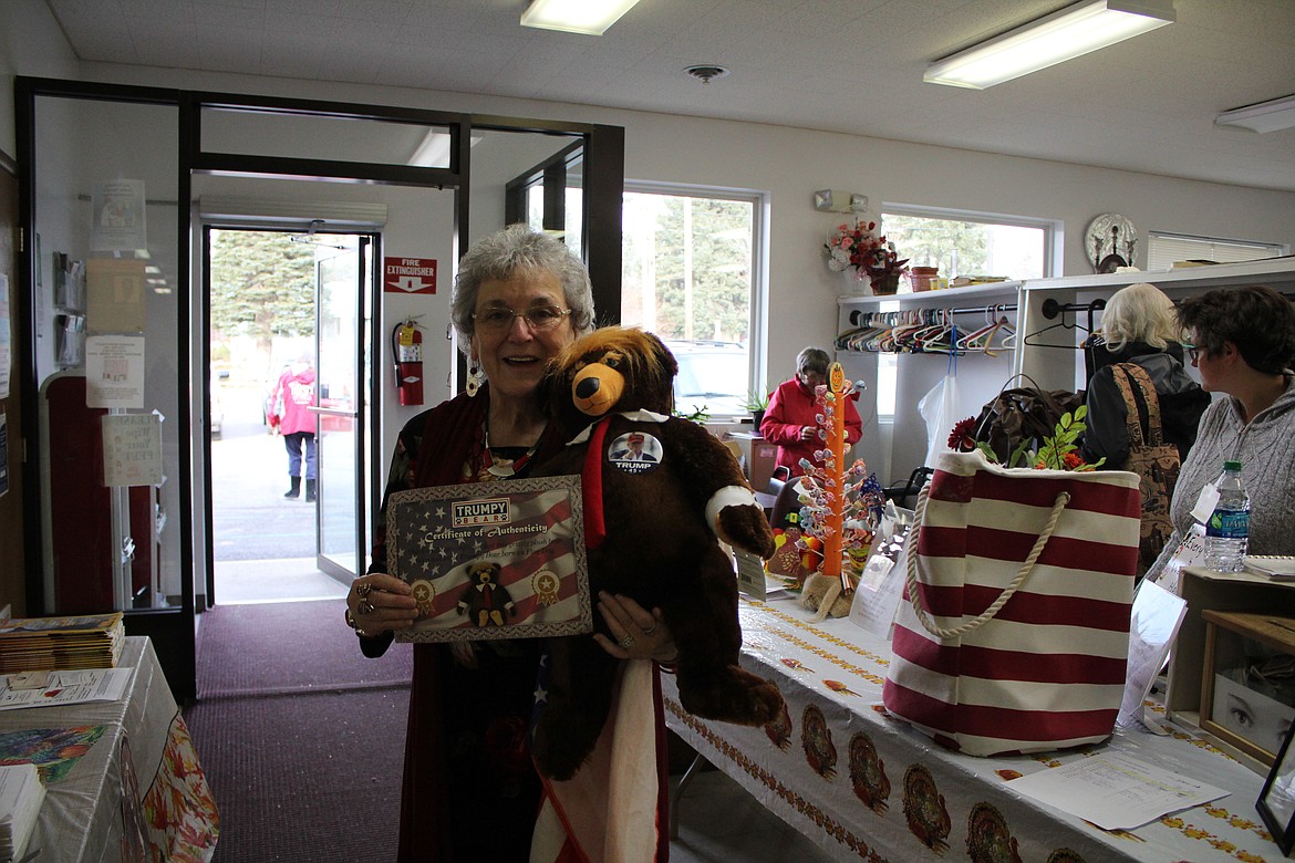 Activity Chairman Nancy Martinez holds up Trumpy Bear and his certificate of authenticity.