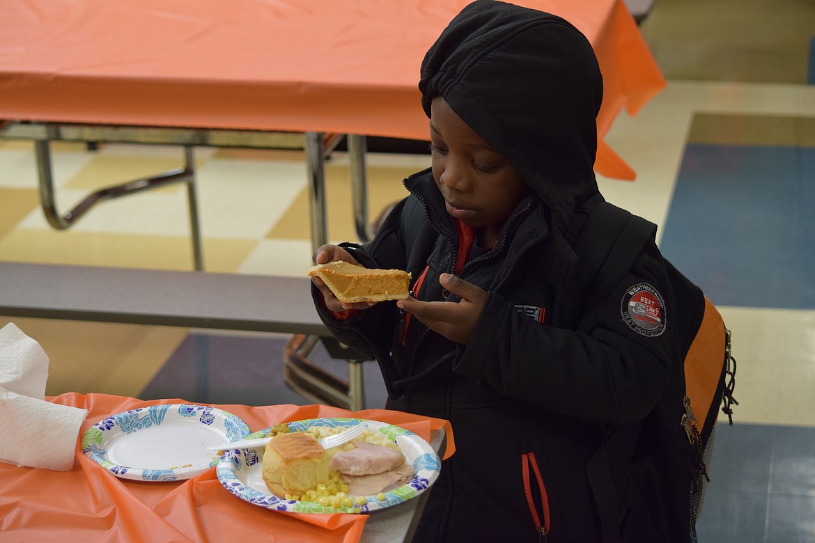 Charles H. Featherstone/Columbia Basin Herald
A kindergartner contemplates his piece of pumpkin pie during the Boys and Girls Club&#146;s family meal on Tuesday.