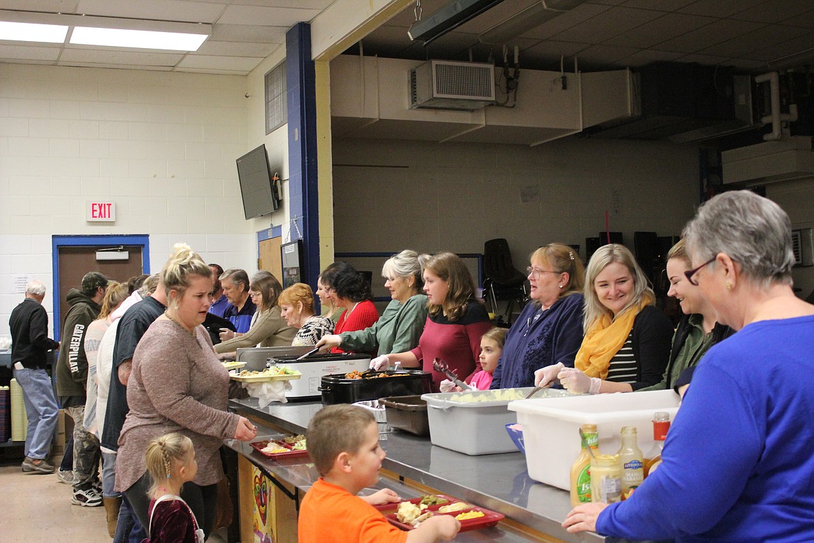 Photo by Tanna Yeoumans
Volunteers line up to serve attendees at Sunday&#146;s free Thanksgiving dinner for the community at Boundary County Middle School.