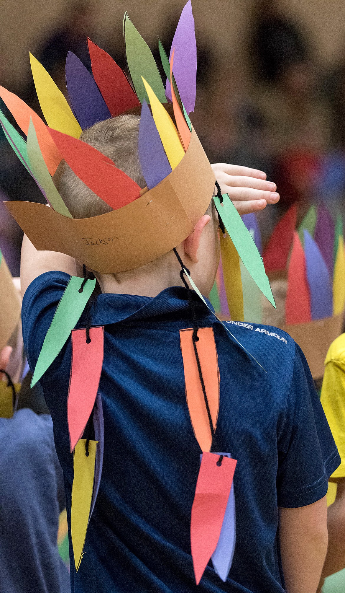 A first-grade boy dons a headdress Tuesday. (John Blodgett/The Western News)