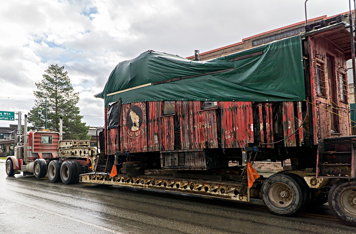 The caboose being transported by semi-truck Thursday morning heads along East Second Street on its way to Columbia Falls. (Daniel McKay/Whitefish Pilot)