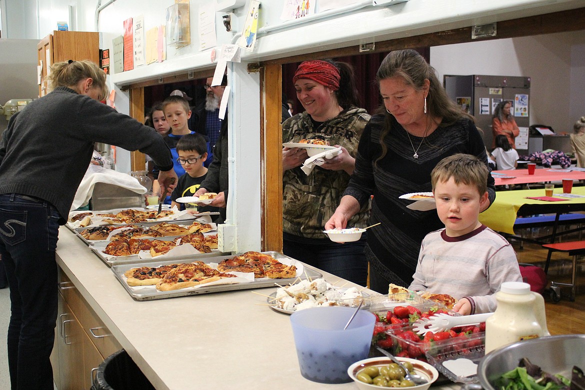 On Oct. 26 the Alberton Afterschool Program celebrated &#147;Lights On&#148; with a dinner of student-made pizza for parents and community members. The program provides a wide array of activities for students including cooking. (Kathleen Woodford/Mineral Independent)0