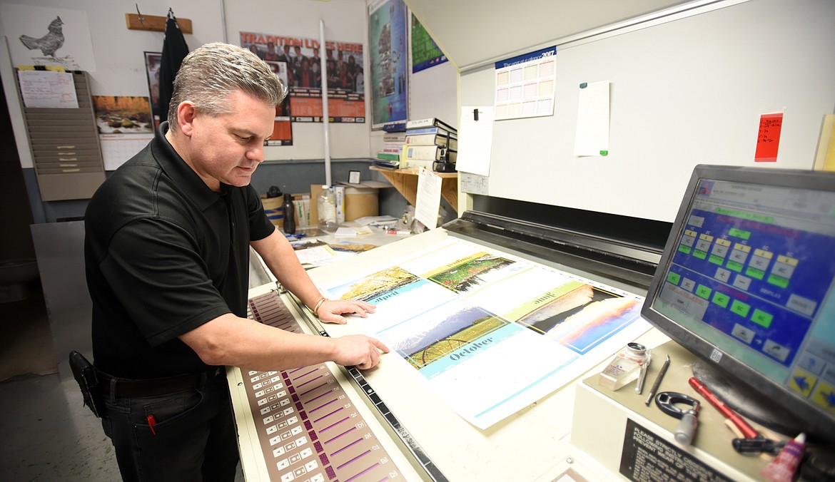 Chad Thomas explains some of what they can do with the six color printing press on Monday, October 30, at Thomas Printing in Kalispell.(Brenda Ahearn/Daily Inter Lake)