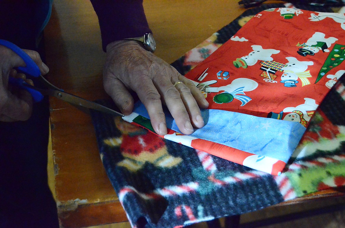 Patterns were cut from Christmas themed fabrics to ensure all stockings were festive or families in need (Erin Jusseaume/ Clark Fork Valley Press)