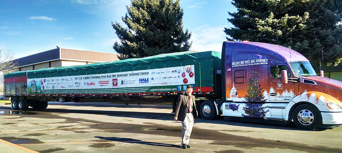 Plains Schools Superintendent Thom Chisholm welcoming Larry and his cousin Donna Redmond to Plains with the aalmighty Christmas tree. (Clark Fork Valley Press)