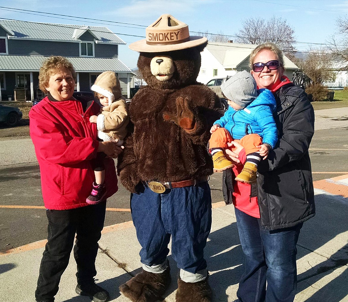 Beth Vacura with daughter Amber and her two children with Smokey Bear (Clark Fork Valley Press)