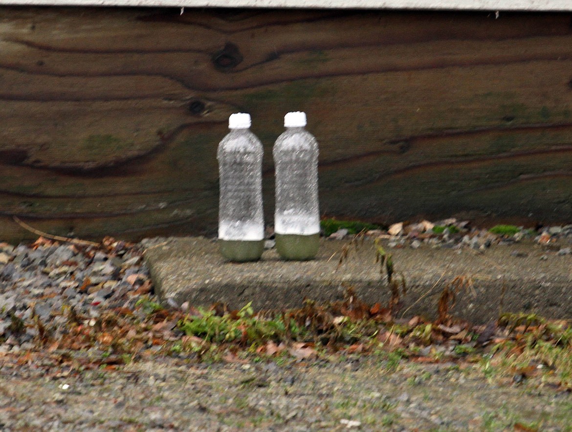 The two bottles containing an unidentified acid.