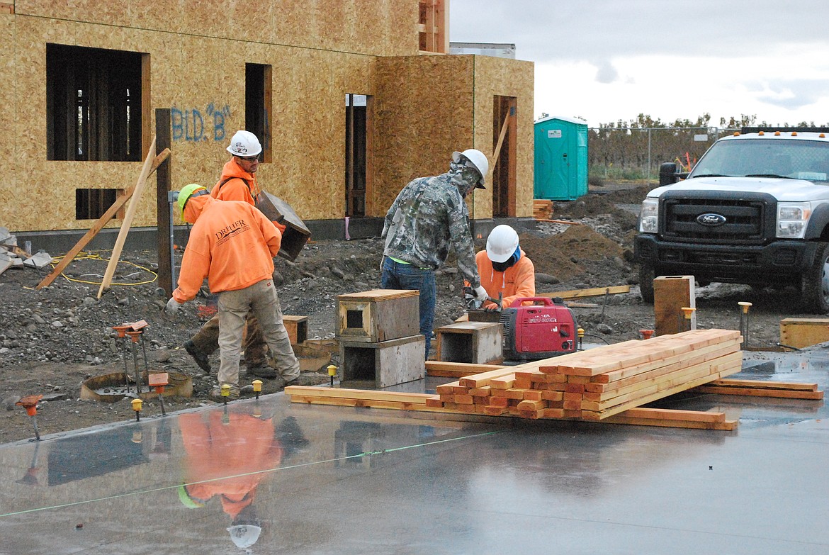 Bob Kirkpatrick/The Sun Tribune - Concrete workers are making forms for one or two remaining buildings in phase one of the project.