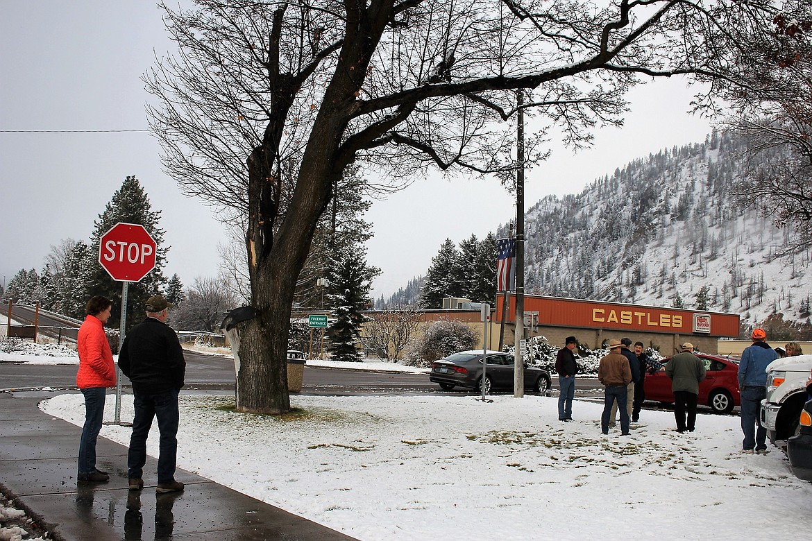 During the Friday commissioners meeting, community members stepped outside to look at the corner where a proposed statue maybe installed. It would require cutting down an aging tree at the congested intersection of River and Fourth Street. (Kathleen Woodford/Mineral Independent)