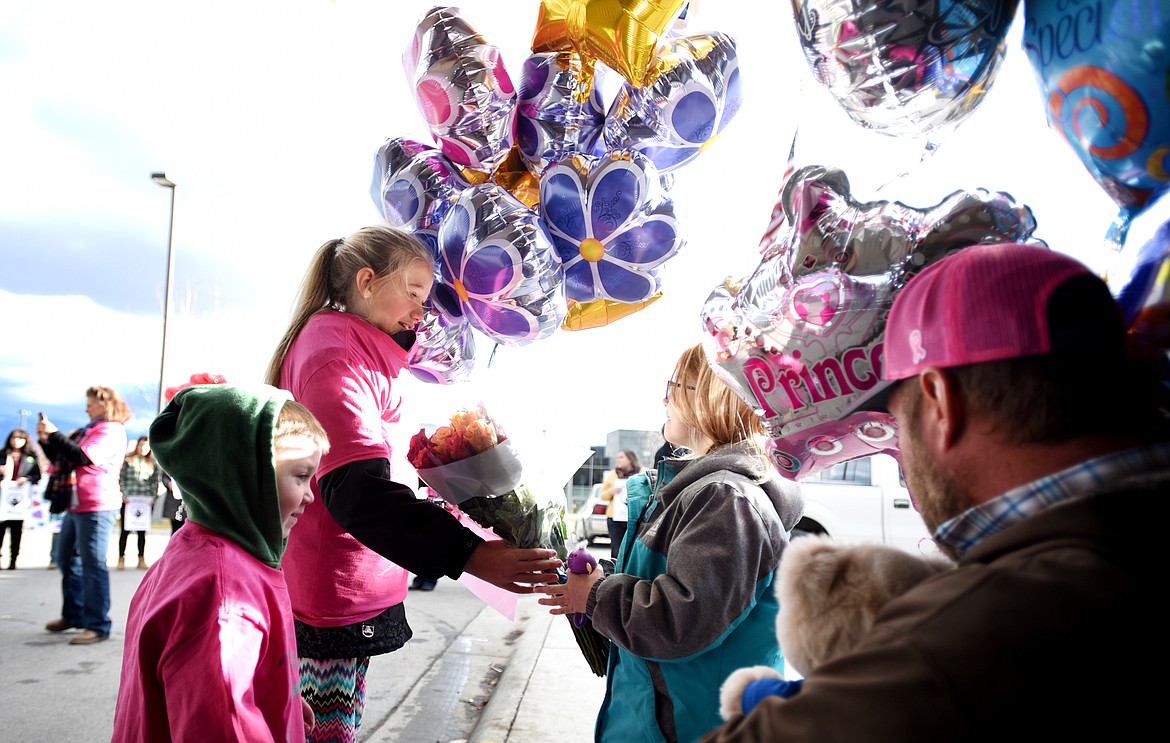 Willow Henke, 6, center, gets balloons and flowers from friends and family when she arrives at The Rock at Kalispell Regional Medical Center on Wednesday, November 29. Henke arrived on horseback for her final chemo treatment.&#160;(Brenda Ahearn/Daily Inter Lake)