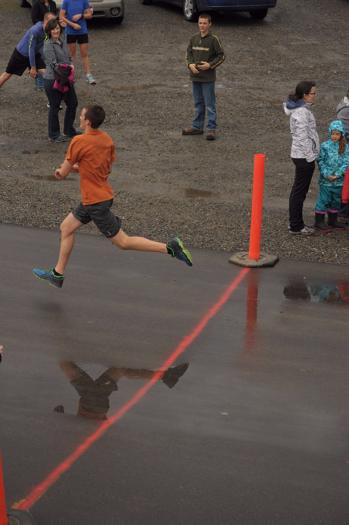 Sam Gorton crosses the finish line with large strides.