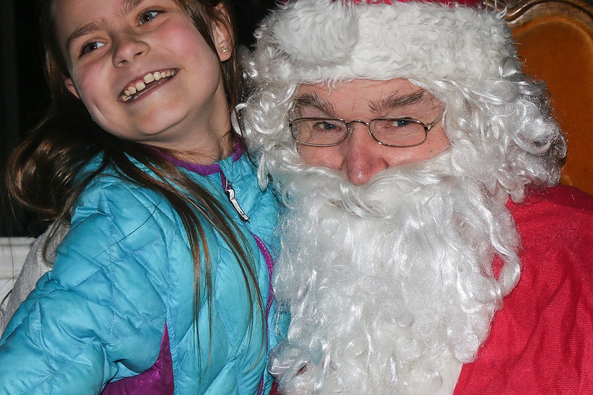 Photo by Mandi Bateman
Alaina Nicoles, 9, has a big smile as she speaks with Santa during his Friday, Nov. 24, visit to downtown Bonners Ferry.