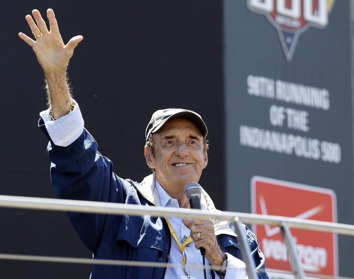 FILE - In this May 25, 2014 file photo, Jim Nabors waves to fans after singing before the start of the 98th running of the Indianapolis 500 IndyCar auto race at the Indianapolis Motor Speedway in Indianapolis. Nabors died peacefully at his home in Honolulu on Thursday with his husband Stan Cadwallader at his side. He was 87. (AP Photo/Michael Conroy, File)