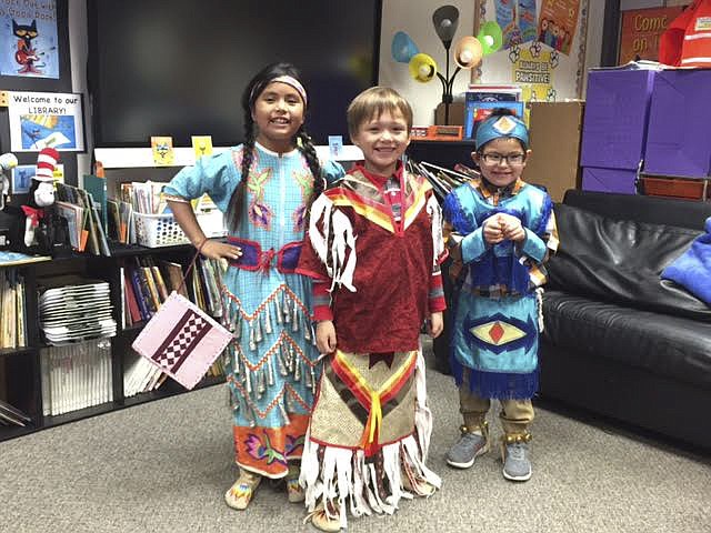 Pictured left to right are second grader Ni&#146;Ellie Yellowhorse, first grader Kaleb Hammer, and Leland Perez, in Kindergarten. The students wore their regalia to show their classmates at Dayton Elementary their clothing as part of a math and heritage lesson. (Photo provided)