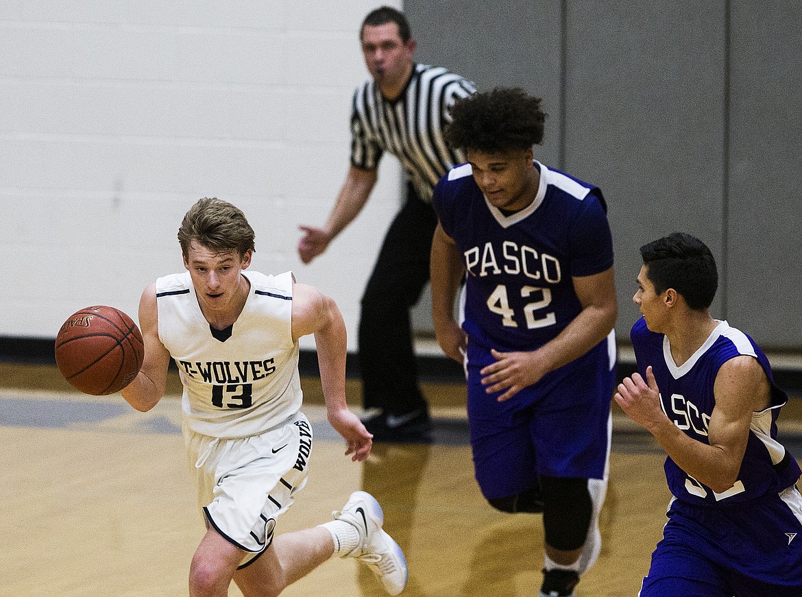 LOREN BENOIT/Press

Lake City&#146;s Kyle Manzardo, left, dribbles the ball down the court against Pasco Friday night at Lake City High School.