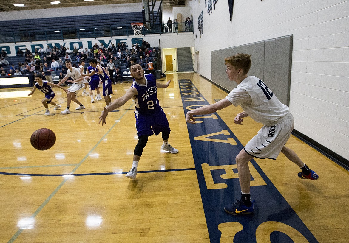 LOREN BENOIT/Press

Lake City guard Nic McCartin passes the ball by Pasco defender in to a teammate by a during Friday night&#146;s game at Lake City