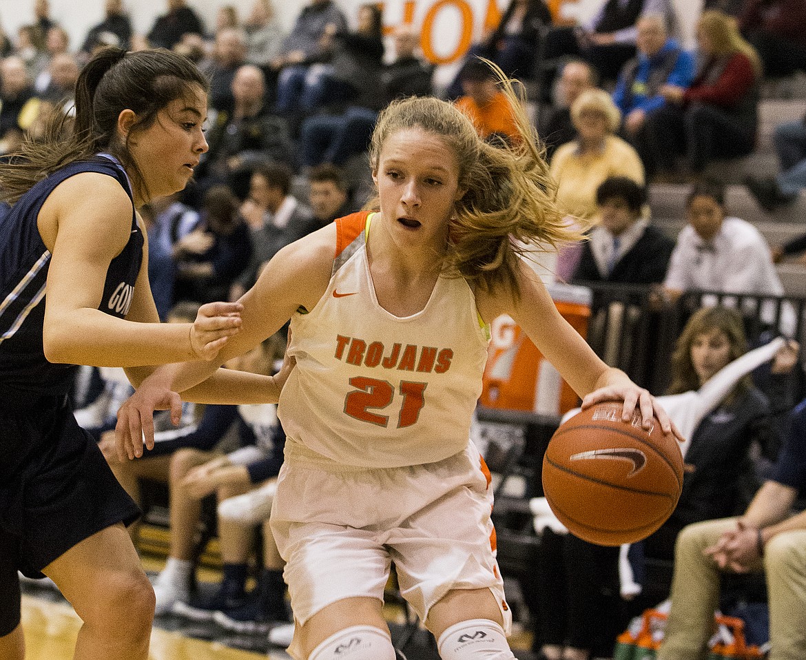 LOREN BENOIT/PressTyler McCliment-Call dribbles the ball by Gonzaga Prep defender Grace Hammon Thursday night at Post Falls High School.