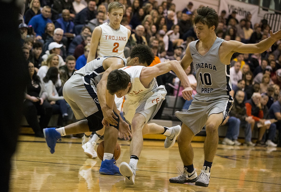 LOREN BENOIT/PressDrake Thompson loses the ball as he drives into the Gonzaga Prep defense Thursday night at Post Falls High School.