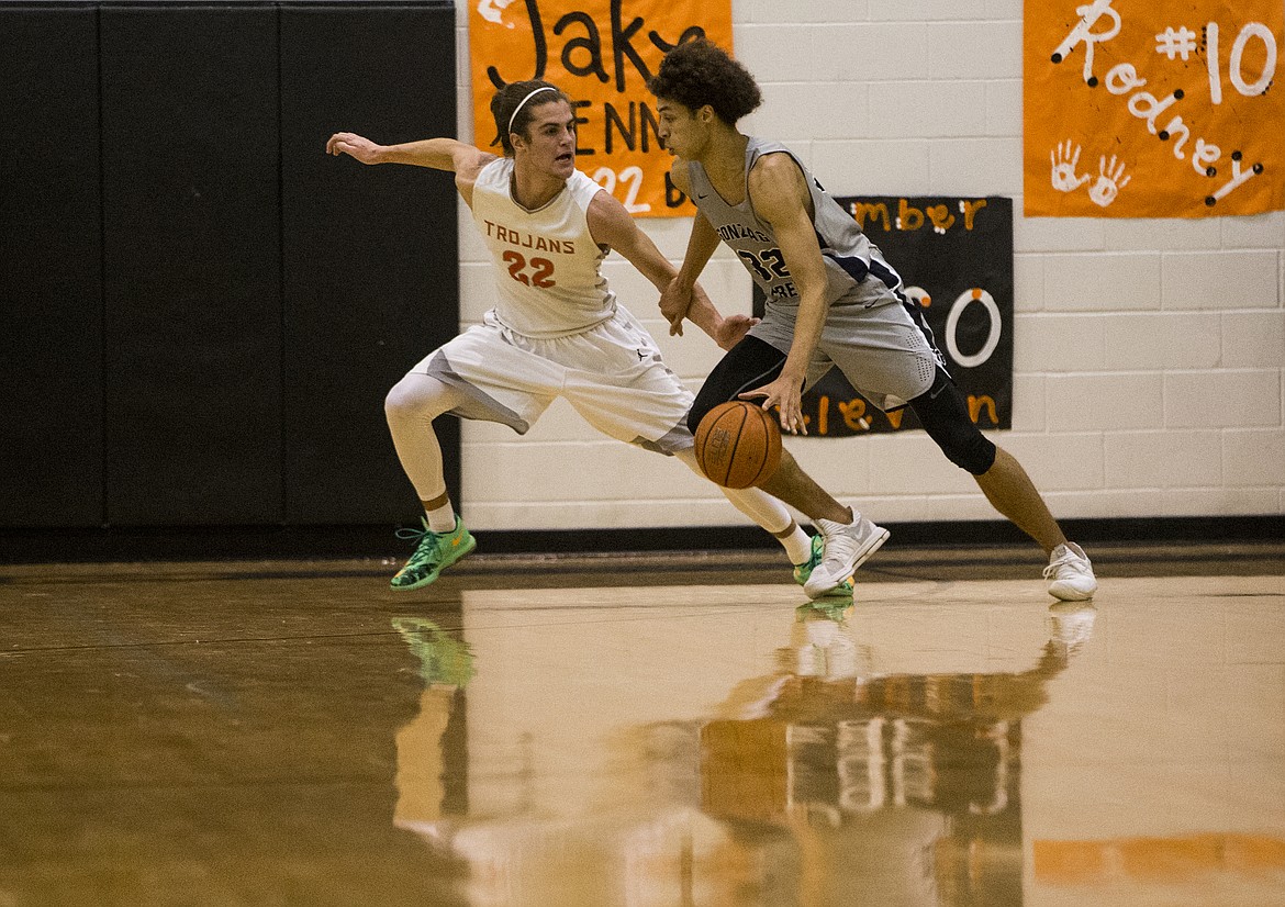 LOREN BENOIT/Press

Anton Watson drives around Post Falls defender Jake Pfennigs Thursday night at Post Falls High School.