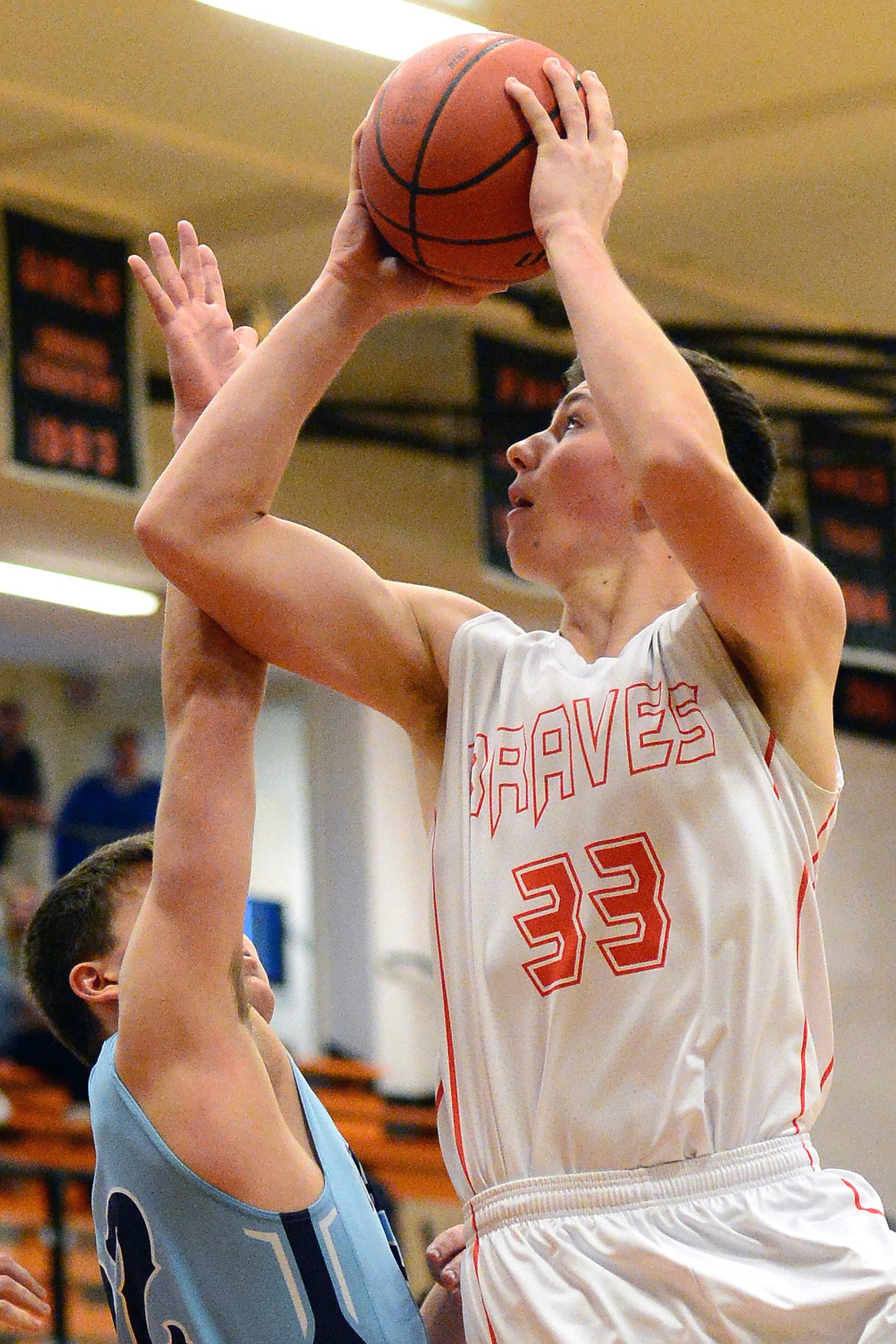 Flathead&#146;s Sam Elliot goes to the hoop past Great Falls defender Kevin Boes. (Casey Kreider/Daily Inter Lake)