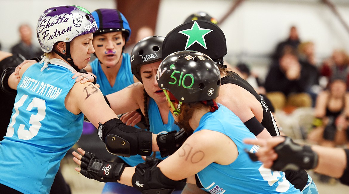 From left, Danika Pietron (Shotta Patron), Co-Captain Jen Johnson (Jenny From the Block) Jeanne Langan (Veruca Slaughter), and Emily Stephenson (Timber Tiger) block a Jammer during the match against the Snake Pit Derby Dames of Coeur d&#146;Alene on Saturday, November 18, at the Flathead County Fairgrounds.(Brenda Ahearn/Daily Inter Lake)