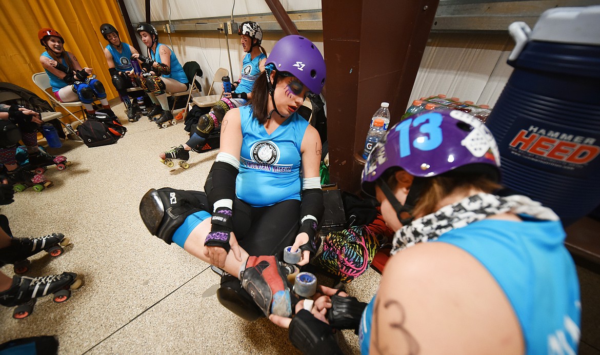 Siina Swanson (IllumiNaughty) gets her skates checked during halftime on Saturday, November 18, at the Flathead County Fairgrounds.(Brenda Ahearn/Daily Inter Lake)