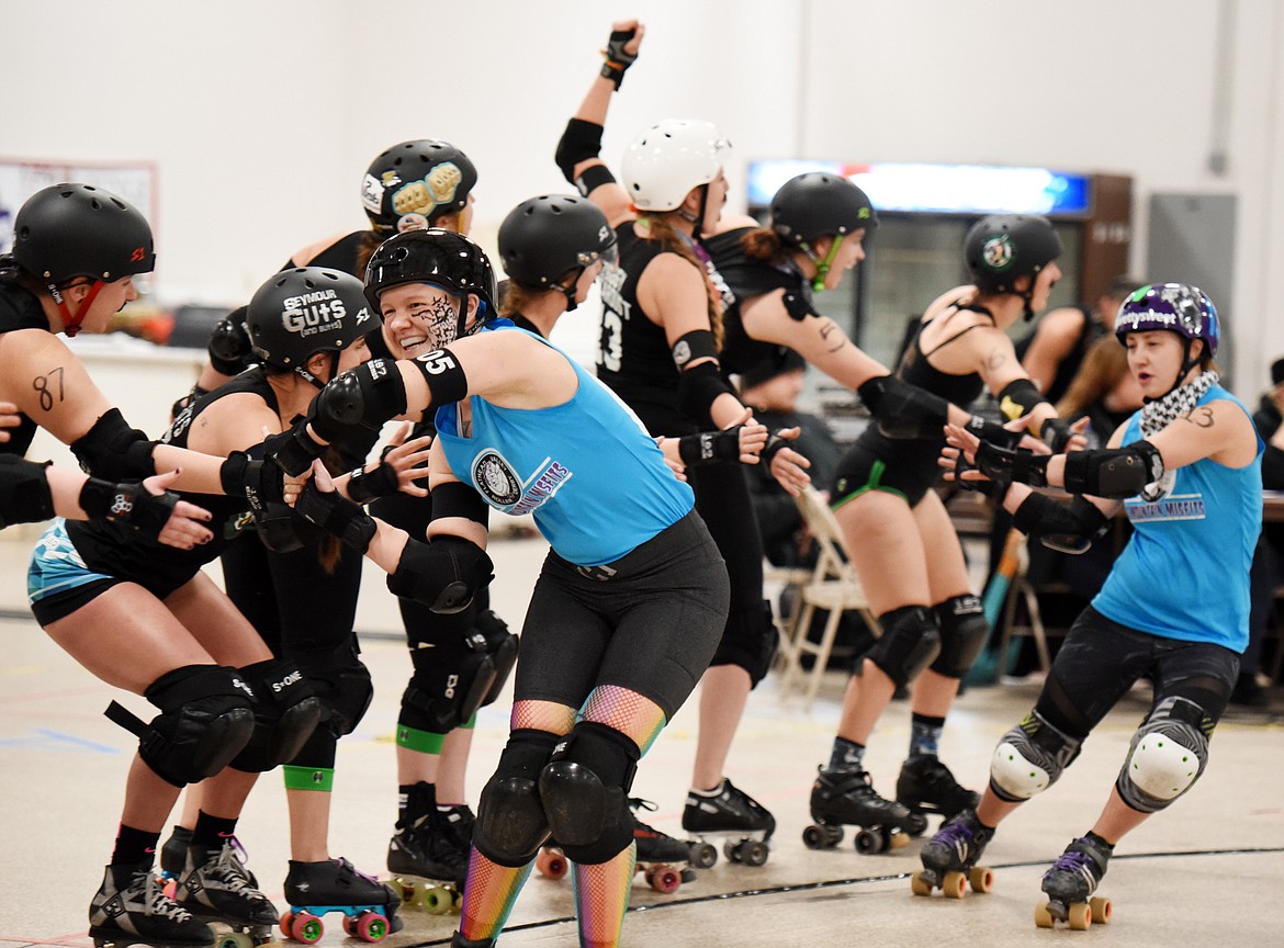 Kari Hammer (Hammer) and Danika Pietron (Shotta Patron) give high fives to the Snake Pit Derby Dames of Coeur d&#146;Alene at the start of their match up on Saturday, November 18, at the Flathead County Fairgrounds.(Brenda Ahearn/Daily Inter Lake)