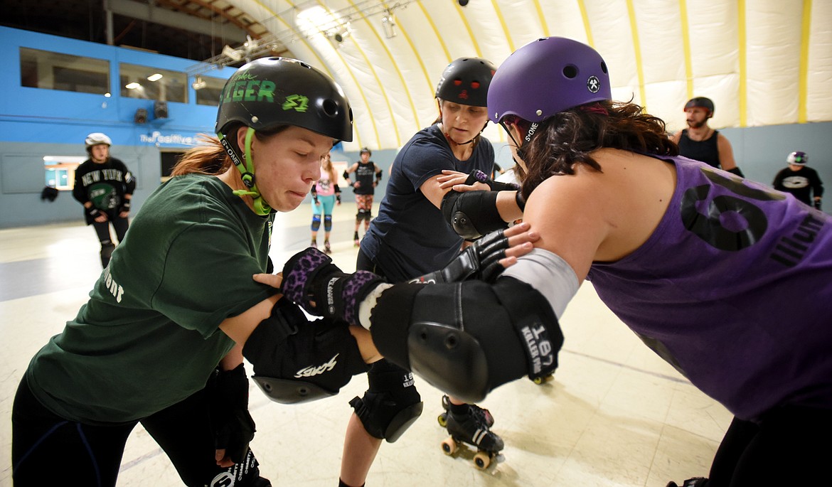 From left, Emily Stephenson (Timber Tiger) Sonja Pirellis Wildt (Sista Sledge) and Siina Swanson (IllumiNaughty) line up for practice on Monday, November 13, in Kalispell. The team was intensely focused knowing they would face tough competition in the upcoming bout with the Snake Pit Derby Dames of Coeur d&#146;Alene.(Brenda Ahearn/Daily Inter Lake)