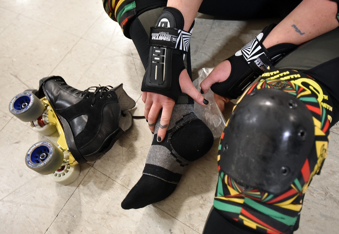 An injured skater ices a sore ankle during practice on Monday, November 13, in Kalispell. According to Team Captain Kari Hammer, &quot;Safety is a core focus of the team, both in-practice and in-game; we follow standard risk management guidelines and wear protective gear at all times while skating (which consists of a helmet, mouthguard, elbow pads, wrist guards, and knee pads.)&#160; Even with those precautions, as&#160;with any sport, injuries are always a risk each player accepts.&#160;&#160;If injured, skaters are encouraged to listen to their bodies, seek professional treatment as needed, and take appropriate rest and physical therapy until they are cleared to return.&#148;(Brenda Ahearn/Daily Inter Lake)