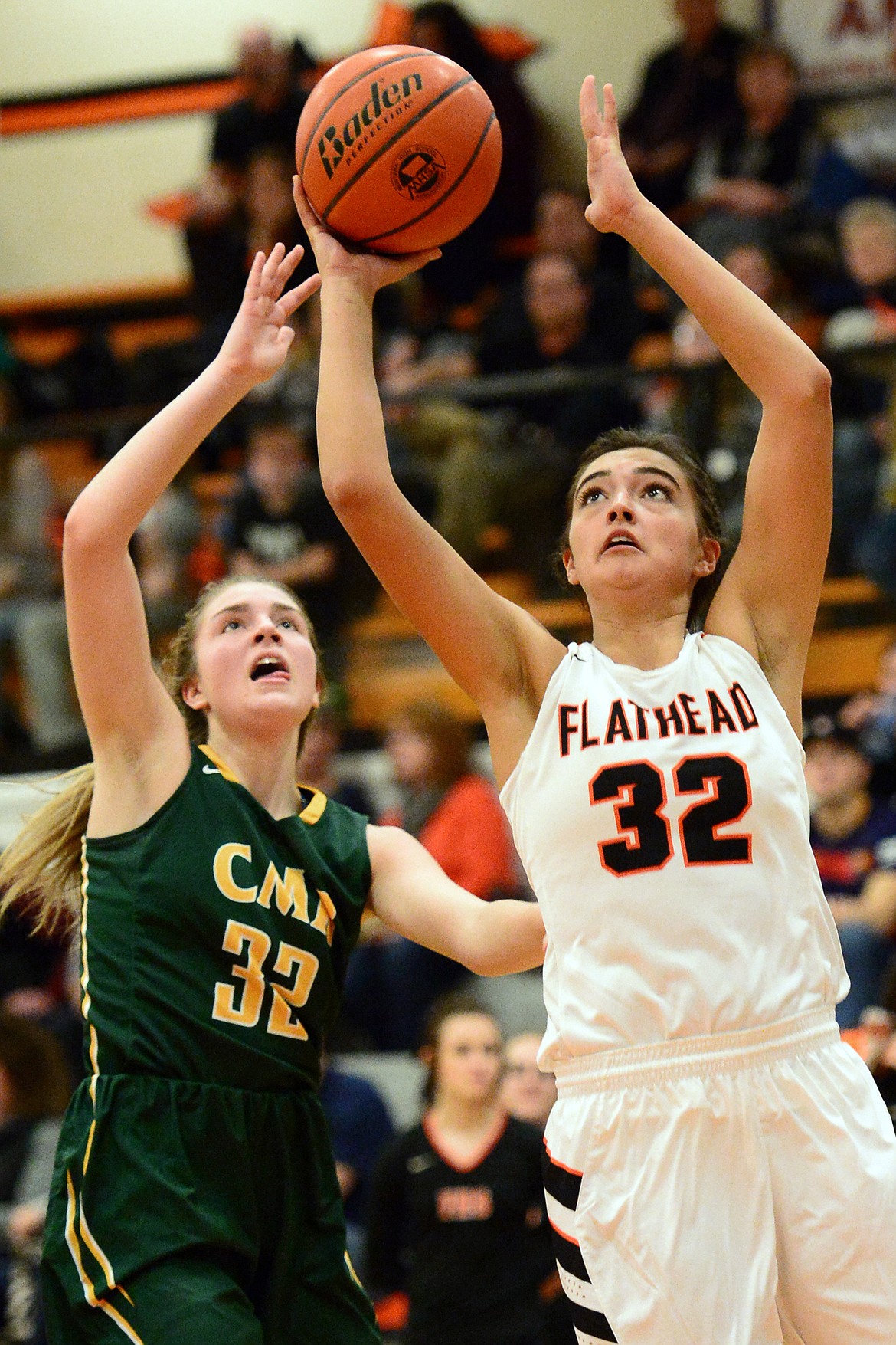 Flathead's Taylor Henley goes to the hoop with C.M. Russell's Brynn Klinefelter defending. (Casey Kreider/Daily Inter Lake)