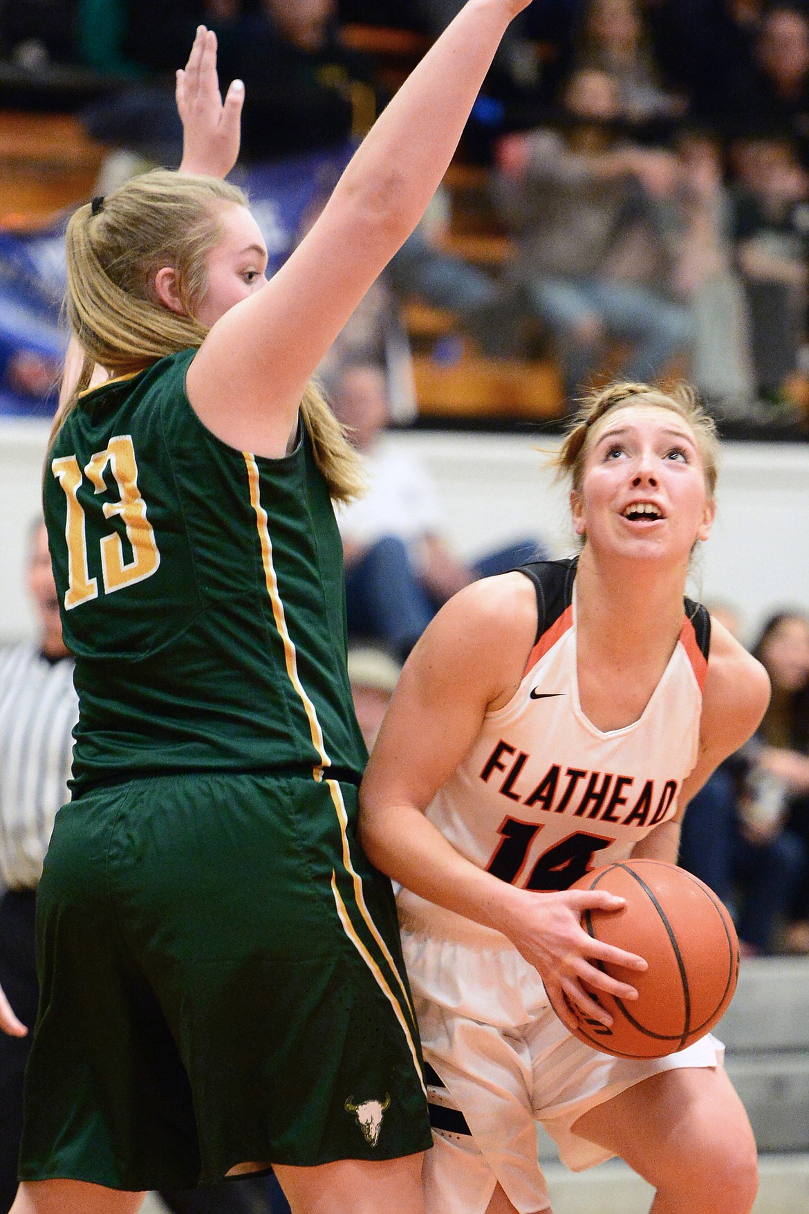 Flathead's Mary Heaton looks to shoot in front of C.M. Russell defender J.J. Slater during the first half. (Casey Kreider/Daily Inter Lake)