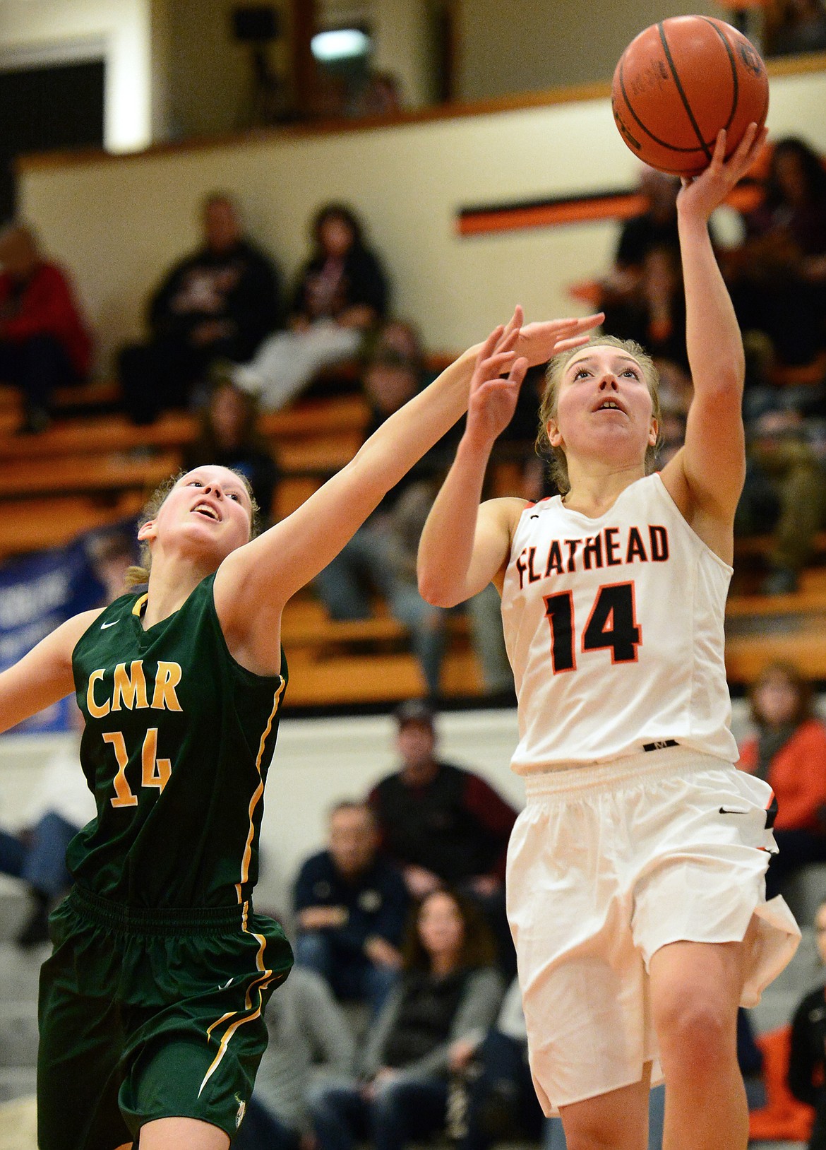 Flathead's Mary Heaton goes to the hoop with C.M. Russell's Allie Olsen defending. (Casey Kreider/Daily Inter Lake)