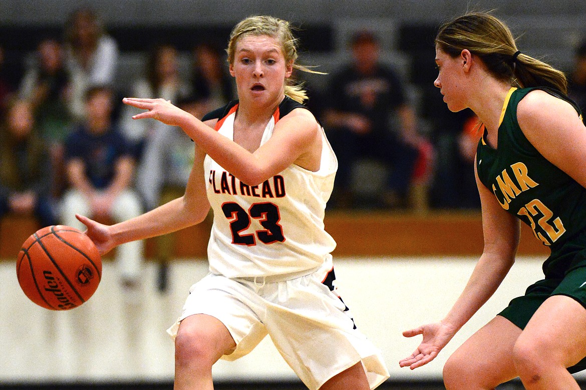 Flathead's Clara Vandenbosch takes the ball upcourt against the defense of C.M. Russell's Kayci Edwards. (Casey Kreider/Daily Inter Lake)