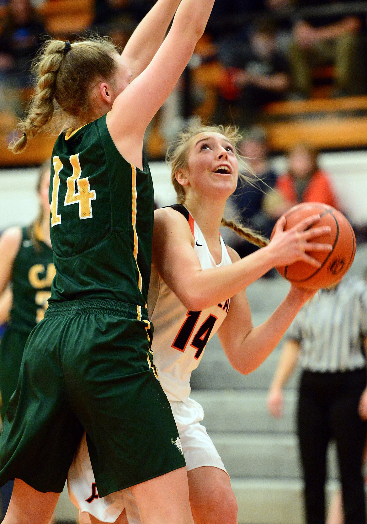 Flathead's Mary Heaton looks to the hoop with C.M. Russell's Allie Olsen defending. (Casey Kreider/Daily Inter Lake)